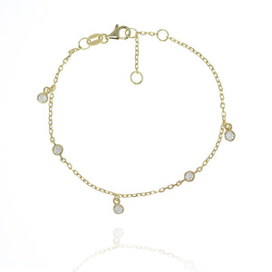 
Gold plated sterling silver chain bracelet with 2 flat bezel-set cubic zirconia and 3 hanging cubic zirconia gems.

