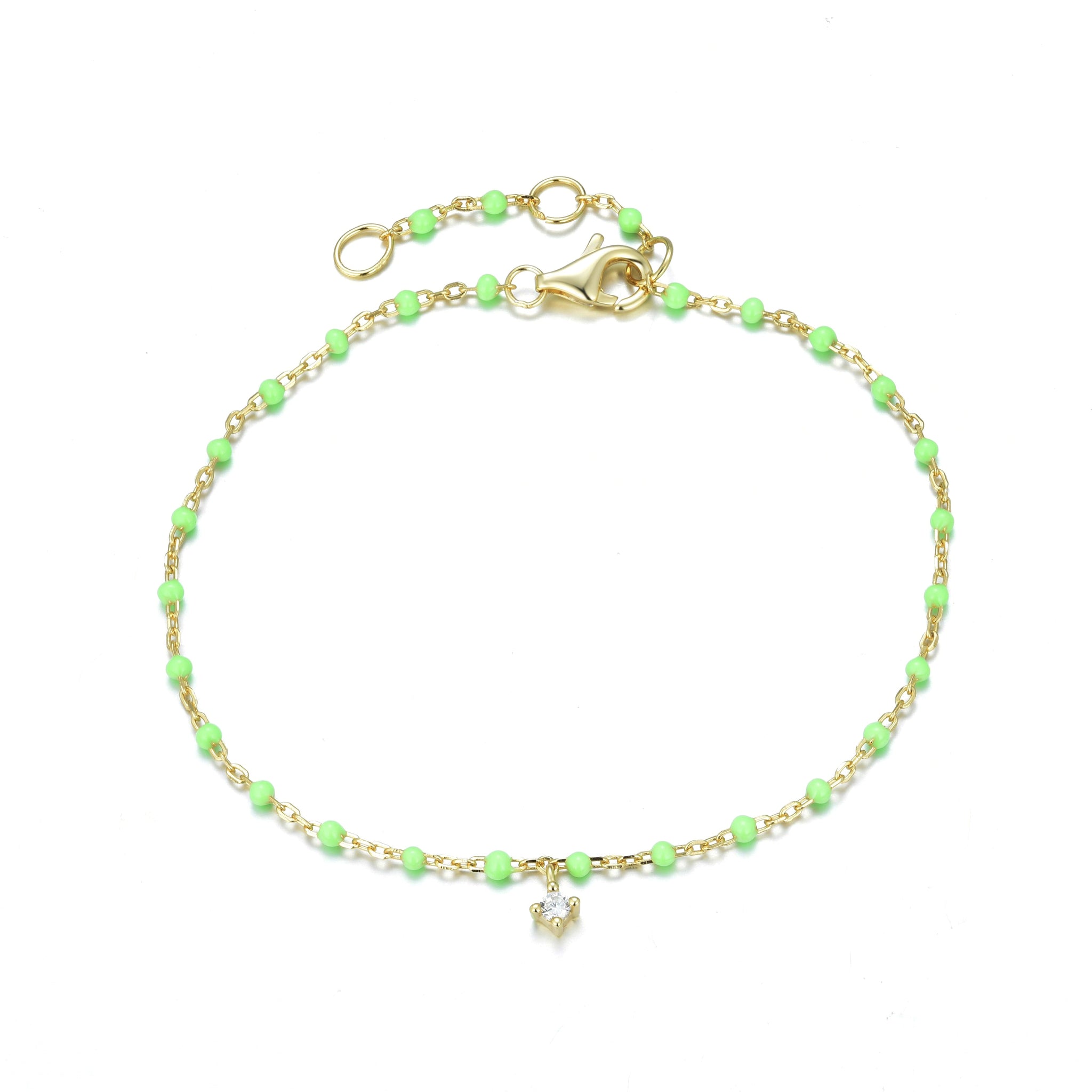 
Gold-plated chain and apple green enamel bead bracelet with a hanging cubic zirconia stone.

