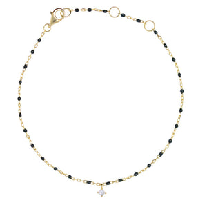 
Delicate gold-plated bracelet with black enamel beads and a small hanging cubic zirconia charm.

