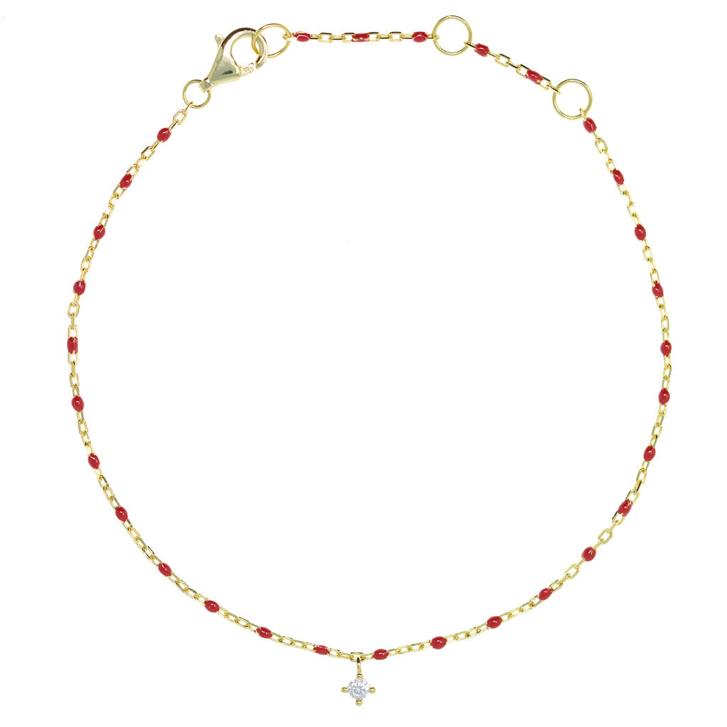 
Gold plated on silver chain and red bead bracelet with hanging cubic zirconia charm.

