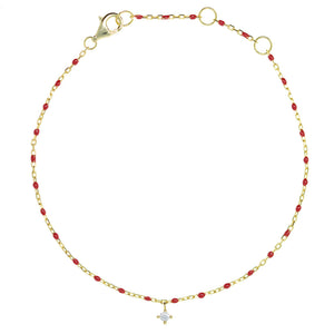 
Gold plated on silver chain and red bead bracelet with hanging cubic zirconia charm.

