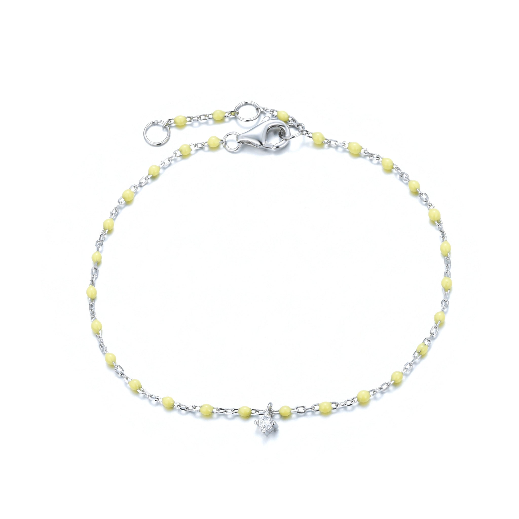 

Sterling silver chain and yellow bead bracelet with hanging zirconia pendant.

