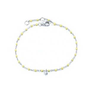 

Sterling silver chain and yellow bead bracelet with hanging zirconia pendant.

