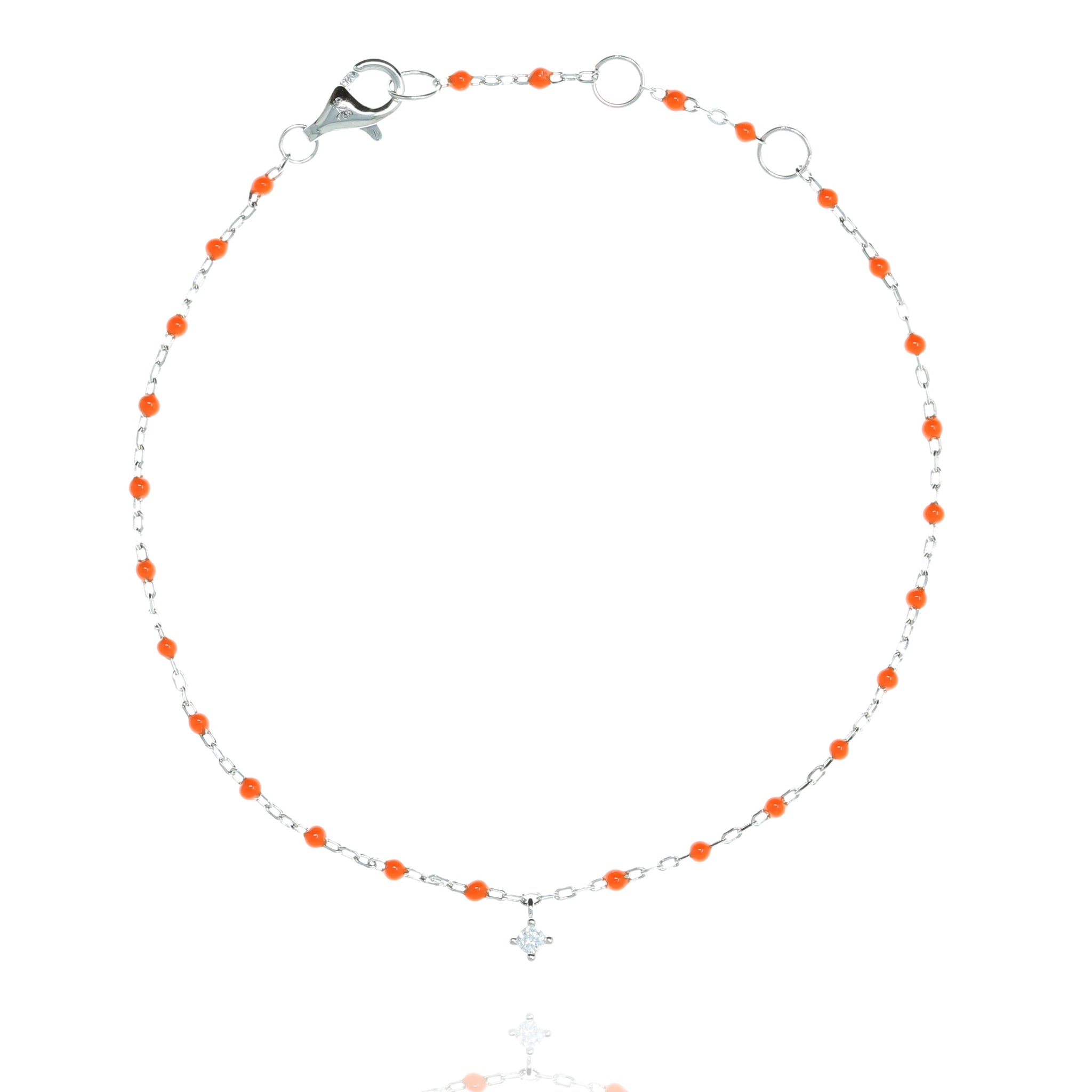 
Sterling silver chain bracelet with orange beads and a hanging CZ charm.

