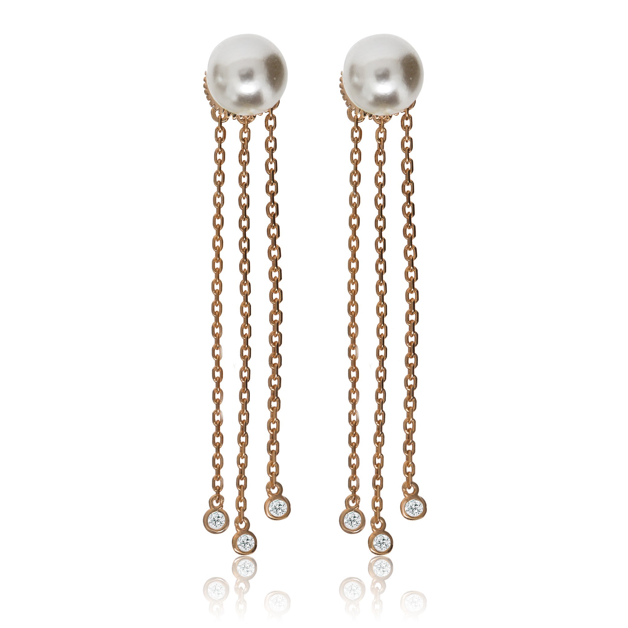 
Rose gold on silver pearl stud earrings with three hanging chains, each featuring a small cubic zirconia gemstone at the end. 

