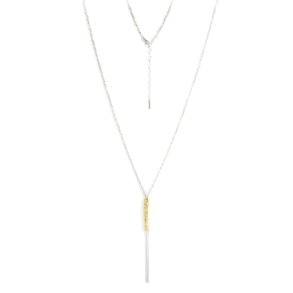 
Sterling silver knitted necklace with a gold-bound hanging chain tassel, displayed  .

