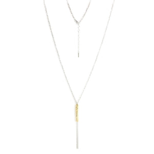 
Sterling silver knitted necklace with a gold-bound hanging chain tassel, displayed  .

