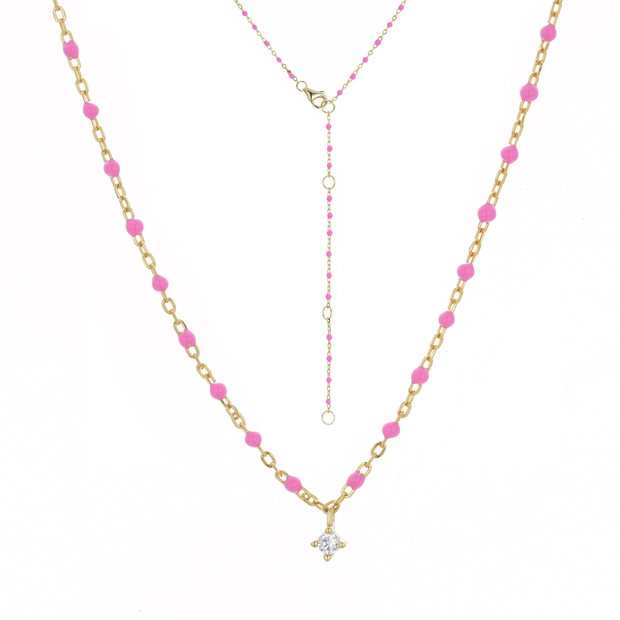 
Gold plated chain and bead necklace with fuchsia beads and hanging Cubic Zirconia.

