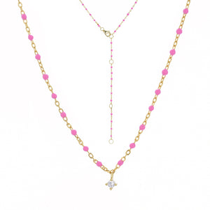 
Gold plated chain and bead necklace with fuchsia beads and hanging Cubic Zirconia.

