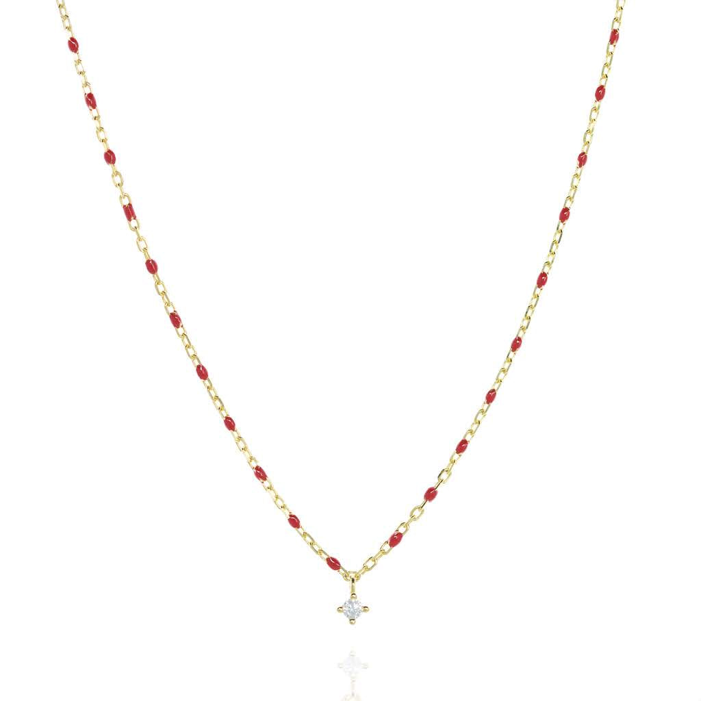 
Gold-plated necklace with red beads and a central Cubic Zirconia pendant.

