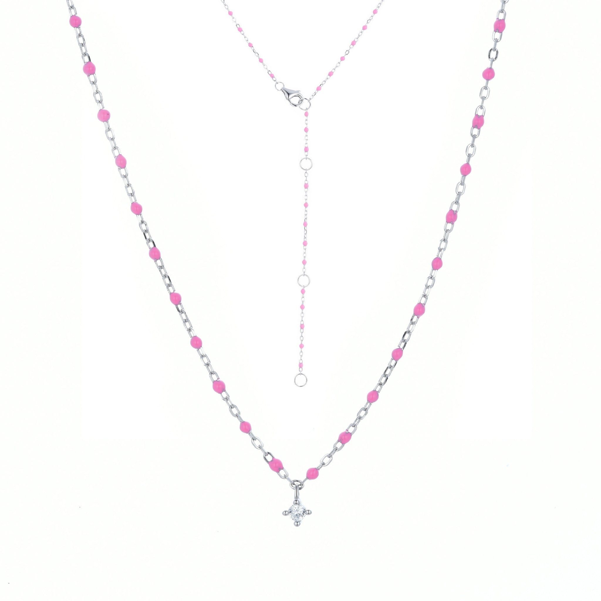 
Sterling silver chain and bead necklace with fuchsia coloured beads and a hanging cubic zirconia pendant.

