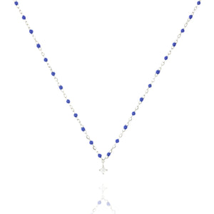 
Sterling silver chain and blue bead necklace with a central small cubic zirconia  .

