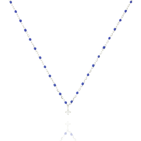 
Sterling silver chain and blue bead necklace with a central small cubic zirconia  .

