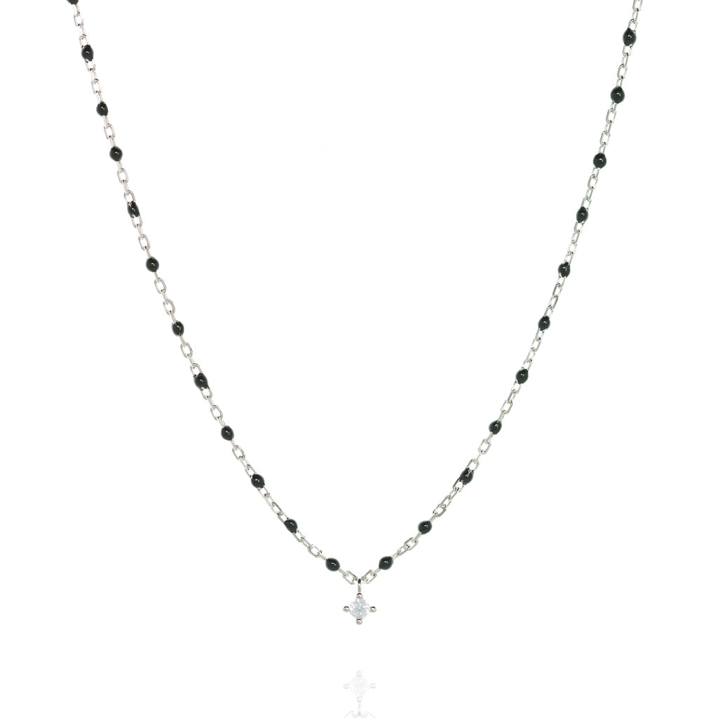 
Sterling silver necklace with black beads and a central small cubic zirconia.

