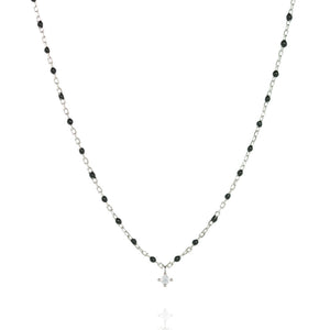 
Sterling silver necklace with black beads and a central small cubic zirconia.

