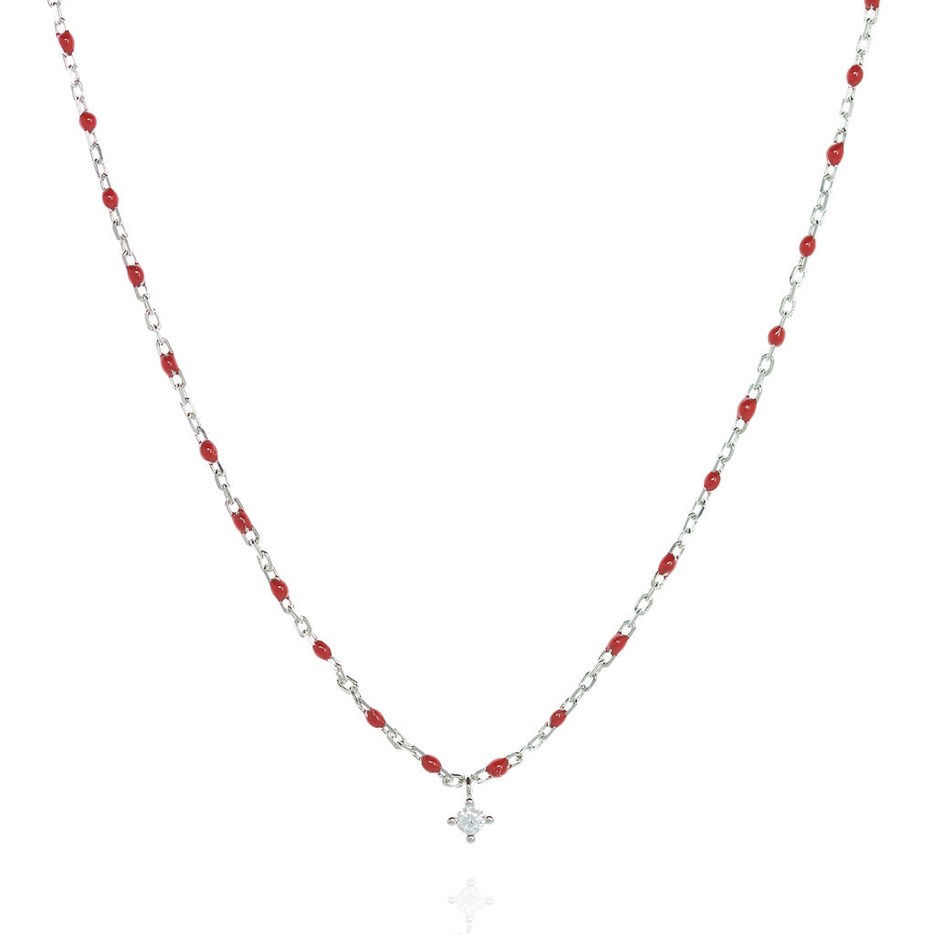 
Sterling silver short chain necklace with red beads and a central small Cubic Zirconia.

