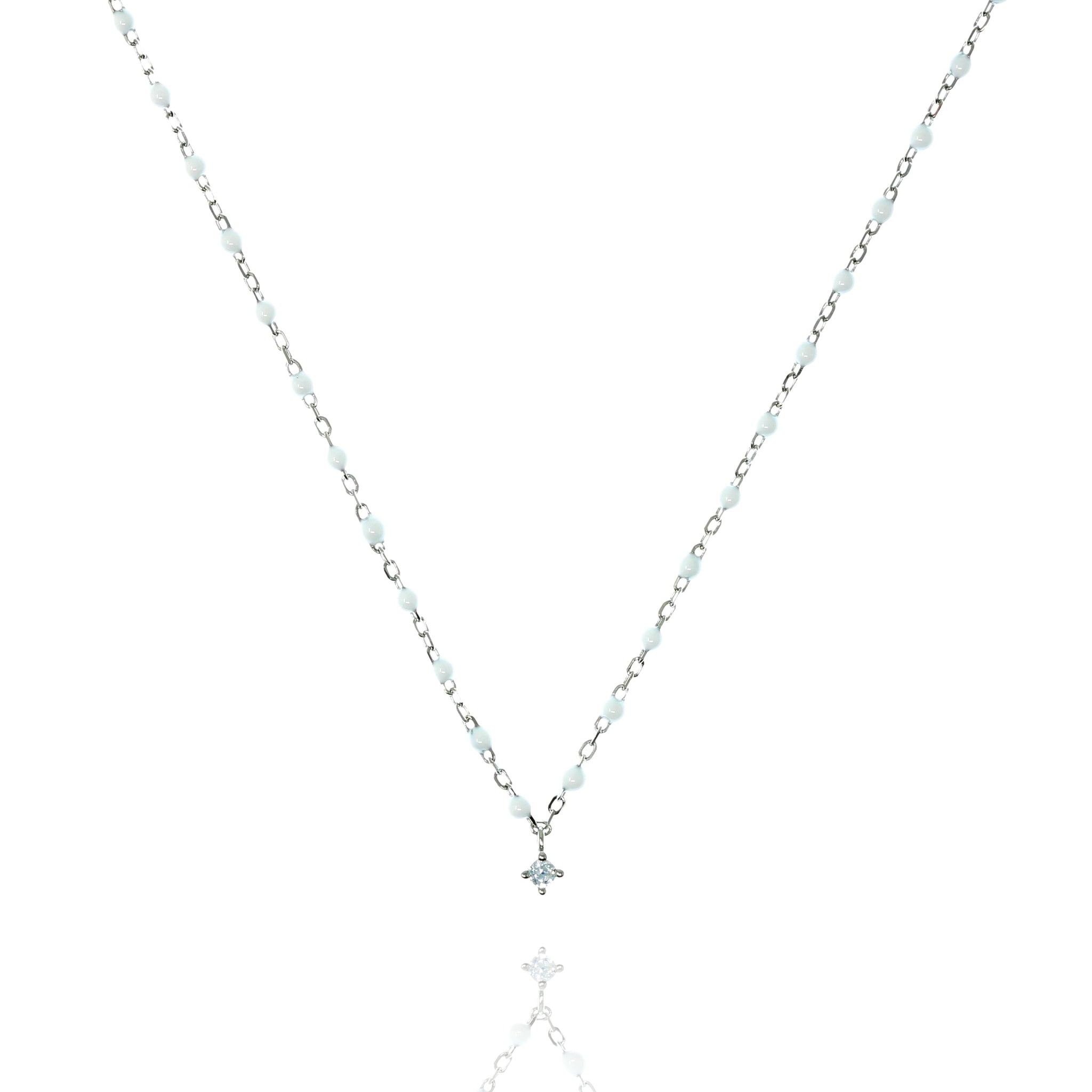 
Sterling silver necklace with white beads and cubic zirconia centrepiece.

