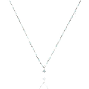 
Sterling silver necklace with white beads and cubic zirconia centrepiece.

